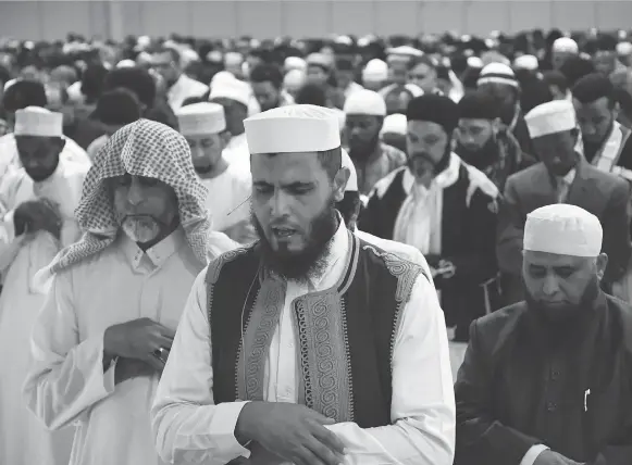  ?? MATT OLSON ?? Special guest Imam Jamal, front, led an estimated 10,000 Saskatoon Muslims in prayer during Eid al-Fitr on Friday.