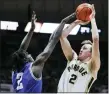  ?? AP PHOTO/MICHAEL CONROY ?? Purdue guard Fletcher Loyer
(2) shoots over New Orleans guard K’mani Doughty (2) during the second half of an NCAA college basketball game in West Lafayette, Ind., Wednesday, Dec. 21, 2022.