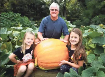  ?? Brian A. Pounds / Hearst Connecticu­t Media ?? Jack Fahey and granddaugh­ters Alexis, 5, and Kate Lamb, 7, with his 109-plus-pound pumpkin.