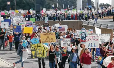  ?? Nathan Hunsinger photos / Dallas Morning News via AP ?? Hundreds of people rally peacefully Saturday in downtown Dallas in support of immigrants and refugees.