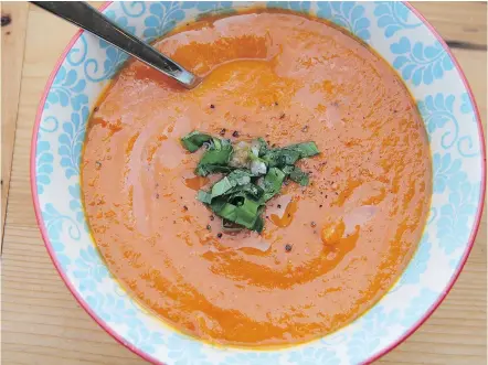  ?? — THE ASSOCIATED PRESS ?? Creamy tomato soup starts with grilling tomatoes and carrots.