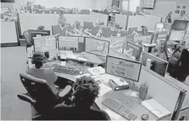  ?? SOUTH FLORIDA SUN SENTINEL
MIKE STOCKER/ ?? Operators answer emergency calls at a Broward County 911 dispatch center.