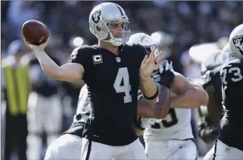  ?? AP PHOTO/BEN MARGOT ?? In this Sunday file photo, Oakland Raiders quarterbac­k Derek Carr passes against the Los Angeles Chargers during the second half of an NFL football game in Oakland.