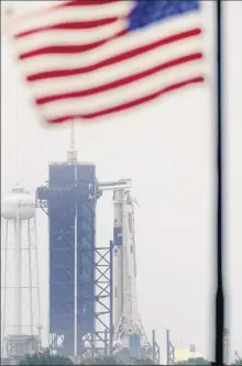  ?? David J. Phillip / Associated Press ?? The Spacex Falcon 9, with the Crew Dragon spacecraft on top of the rocket, sits Monday on Launch Pad 39-A at Kennedy Space Center, Fla. Two astronauts will fly on the Spacex Demo-2 mission to the Internatio­nal Space Station on Wednesday.