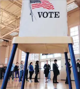  ?? Bob Chamberlin Los Angeles Times ?? VOTERS CAST ballots in Hermosa Beach in March 2015. Hundreds of thousands have recently signed up to vote, but experts wonder whether they’ll show up.