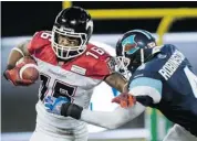  ?? The Canadian Press/nathan Denette ?? Calgary wide receiver Marquay McDaniel, left, fights off a tackle from Toronto defensive back Jamie Robinson.