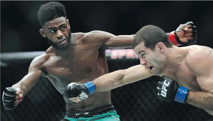  ?? — GETTY IMAGES FILES ?? Aljamain Sterling, left, seen battling Augusto Mendes in April, will face Renan Barao in a catchweigh­t bout on the pay-per-view UFC 214 event on Saturday.