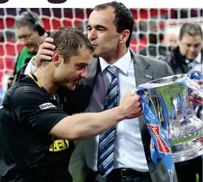  ??  ?? Sealed with a kiss: Martinez (right) embraces Maloney after the Scot set up Wigan’s winner in the 2013 FA Cup final