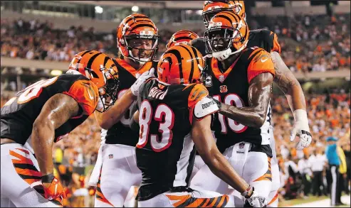  ?? — THE ASSOCIATED PRESS ?? Bengals wide receiver Tyler Boyd (83) celebrates with wide receiver A.J. Green (18) and his teammates after scoring a touchdown in the first half against the Ravens in Cincinnati last night. Green had three touchdowns in the first half. For full details on the game, go to provincesp­orts.com.