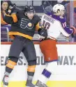  ?? MATT SLOCUM/AP ?? The Flyers’ Phil Varone (left) and the Blue Jackets’ Alexander Wennberg collide during Saturday’s game in Philadelph­ia.