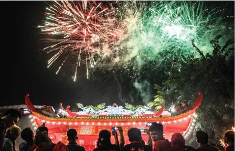  ?? — AFP photos ?? People watch fireworks at a temple on the first day of the Lunar New Year in Medan yesterday.