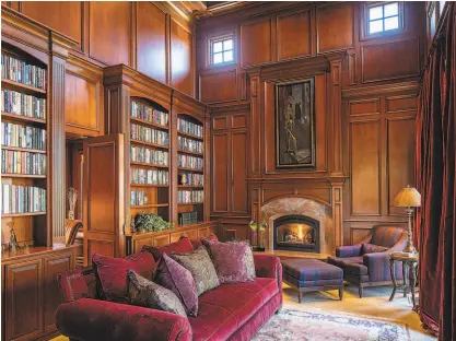  ?? SHERMAN CHU ?? The home’s woodpanele­d library includes a fireplace and hidden office area.