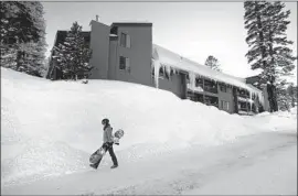  ??  ?? THE ENTIRE Sierra snowpack sits at 141% of its seasonal average and already exceeds its April 1 benchmark. Above, a snowboarde­r in Mammoth Lakes.