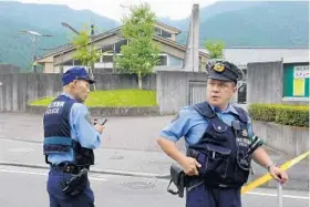  ?? JIJI PRESS/AFP/GETTY IMAGES ?? Police officers stand guard outside a care center for the disabled in Sagamihara, near Tokyo, after a man went on a rampage today, using a knife to kill and wound people.