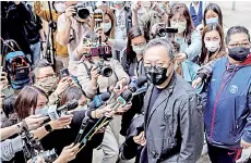  ??  ?? Hong Kong law professor and pro-democracy activist Benny Tai (centre) speaks to the press outside Ma On Shan police station in Hong Kong, where he and 46 other dissidents were each charged with one count of “conspiracy to commit subversion” under the city’s new national security law.
