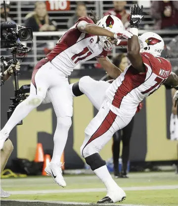  ??  ?? SANTA CLARA: Arizona Cardinals wide receiver Larry Fitzgerald (11) celebrates his touchdown reception with guard Earl Watford during the second half of an NFL football game against the San Francisco 49ers in Santa Clara, California on Thursday.—AP