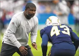  ?? Kyusung Gong Associated Press ?? THE CHARGERS promoted Derrick Ansley, pictured working with cornerback Michael Davis in 2021, from secondary coach to defensive coordinato­r in February.