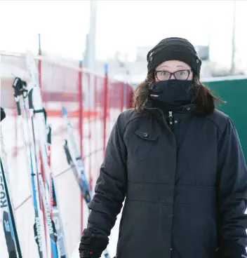  ?? KAYLE NEIS ?? Kirsten Routledge, whose son Aidan was participat­ing in a winter triathlon, is dressed for the chilly temperatur­es as she stands outside the winter track at Gordie Howe Bowl on Thursday.