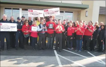  ?? NEWS-SENTINEL PHOTOGRAPH­S BY DANIELLE VAUGHN ?? People, including Lodi Mayor Alan Nakanishi, cheer as Lodi Grocery Outlet owner and operator Kevin Trimlett cuts the ribbon during the ribbon-cutting ceremony for the Lodi store on Thursday.