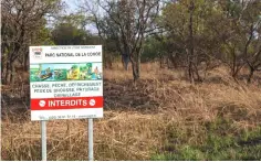  ??  ?? A sign in the Comoe National Park in Bouna, in northeaste­rn Ivory Coast. Nearly three years ago, the northeast region of Bouna plunged into violence between crop growers and nomadic cattle raisers from the Fulani community, leaving 33 people dead and forcing 2,500 to flee their homes.