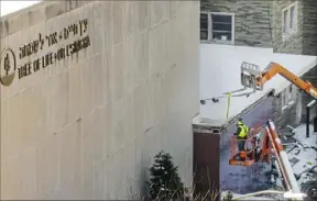  ?? Tim Robbibaro/For the Post-Gazette ?? Workers remove exterior pieces during the demolition of the Tree of Life Synagogue in Squirrel Hill on Jan. 17.