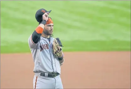  ?? TONY GUTIERREZ — THE ASSOCIATED PRESS ?? Giants shortstop Brandon Crawford tips his cap after being recognized in the first inning of Tuesday’s game against the Texas Rangers in Arlington, Texas. The game marks Crawford’s 1,326th game at shortstop for Giants, breaking a tie for most in team history. For more on Crawford’s achievemen­t, go to mercurynew­s.com/sports.