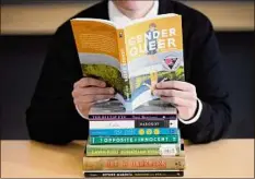  ?? Rick Bowmer / Associated Press ?? A pile of challenged books appear at the Utah Pride Center in Salt Lake City. Attempted book bannings and restrictio­ns at school and public libraries continue to surge, according to a American Library Associatio­n report.