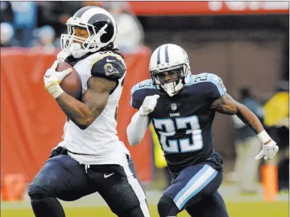  ?? Mark Zaleski ?? The Associated Press Rams running back Todd Gurley leaves Titans cornerback Brice Mccain behind as he heads for the end zone on an 80-yard pass reception during the first half Sunday in Nashville, Tenn.