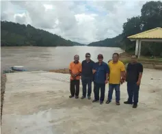  ??  ?? Jamit (centre) and his service centre staff at the recently completed RC Ramp at Nanga Melipis.