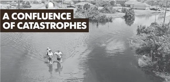  ?? RODNEY WHITE AND MICHAEL ZAMORA, THE DES MOINES REGISTER ?? Residents walk through flooded streets back to their homes Sept. 12 after Hurricane Irma passed through Florida.