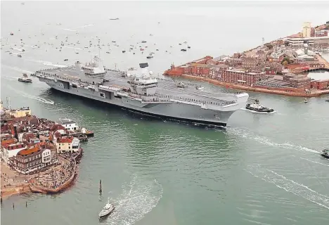  ??  ?? HMS Queen Elizabeth, the UK’s newest aircraft carrier, arrives in Portsmouth