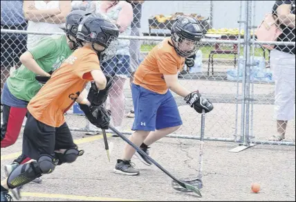  ?? FRAM DINSHAW – TRURO DAILY NEWS ?? Zayne O’dwyer from the ODR Hockey Club charges after the ball at the Hubtown Street Hockey tournament at in the Colchester Legion Stadium’s parking lot on Saturday. His team was playing against the Truro Bearcats.
