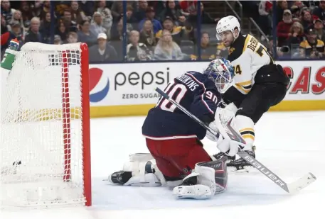  ?? Ap ?? ZIPPING UP THE JACKETS: Jake DeBrusk scores the first of his two goals against the Columbus Blue Jackets in a 32 victory for the Bruins last night.