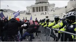  ?? JULIO CORTEZ — THE ASSOCIATED PRESS FILE ?? Trump supporters try to break through a police barrier at the Capitol on Jan. 6.