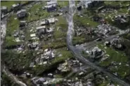  ?? GERALD HERBERT — THE ASSOCIATED PRESS FILE ?? In this file photo, debris scatters a destroyed community in the aftermath of Hurricane Maria in Toa Alta, Puerto Rico.