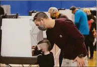  ?? H John Voorhees III / Hearst Connecticu­t Media file photo ?? Bryson Grimm, 5, helped his father Kevin Grimm, of Danbury, vote last year. Connecticu­t Democrats are lobbying for the state to vote early in 2024 primaries. If selected, Connecticu­t Democrats could have greater influence over their party’s pick for the country’s top job.