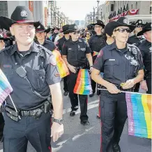  ?? LYLE ASPINALL/FILES ?? The Calgary Police Service flies its colours in the Pride parade in 2014. Police will not have an entry in this year’s event.