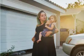  ??  ?? Brittny Daskey, her partner and daughter recently lost their home in Lake Hughes, California. Photograph: Damon Casarez/The Guardian