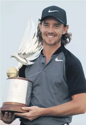  ?? Picture: Reuters ?? Tommy Fleetwood of England poses with the trophy after winning the Abu Dhabi Golf Championsh­ip in the capital of the United Arab Emirates yesterday.