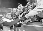  ?? CHARLIE RIEDEL/ASSOCIATED PRESS ?? Tennessee Titans QB Marcus Mariota celebrates with fans after the team secured its first playoff win in 14 years.