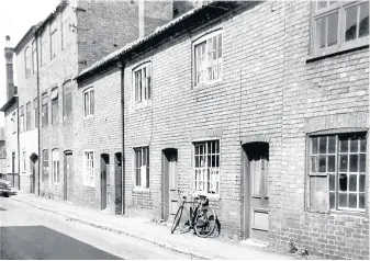  ??  ?? Pictured is Moira Street with Brian’s uncle Tom’s bicycle outside of their front window.