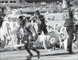  ?? RICHARD SHIRO/AP ?? Coastal Carolina's Reese White, center, scores a touchdown against BYU on Saturday.