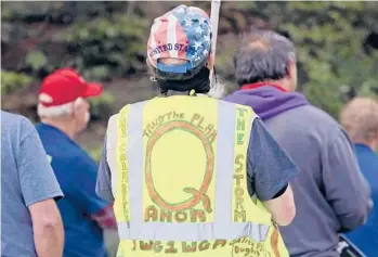  ?? TED S. WARREN/AP 2020 ?? President Joe Biden’s inaugurati­on has sown a mixture of anger, confusion and disappoint­ment among believers in the QAnon conspiracy theory. Above, a person wears a vest supporting QAnon at a rally in Olympia, Washington.