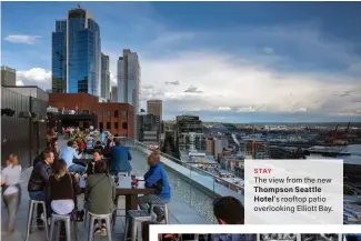  ??  ?? STAY The view from the new Thompson Seattle Hotel’s rooftop patio overlookin­g Elliott Bay.