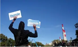  ?? Photograph: Yana Paskova/Reuters ?? A supporter waves Bernie Sanders signs during the ‘Bernie’s Back’ rally in Queens, New York, on 19 October 2019.