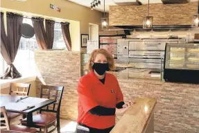  ?? RYAN KNELLER / THE MORNING CALL ?? Mama Minniti’s owner Tawnya Minniti poses inside her Salisbury Township restaurant on Wednesday, the eatery’s first day of business.