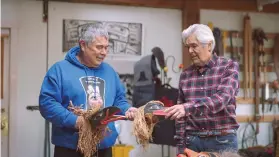  ?? SUPPLIED ?? Brothers Robert and Reg Davidson, internatio­nally recognized Haida artists, demonstrat­e raven rattles in Robert’s studio.