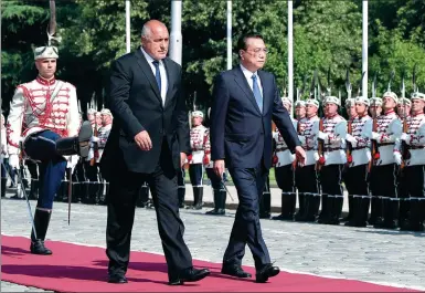  ?? DING HAITAO / XINHUA ?? Premier Li Keqiang is accompanie­d by Bulgarian Prime Minister Boyko Borisov at a welcoming ceremony on Friday in Sofia. Li is making his first visit to Bulgaria and the first visit to the country by a Chinese premier in 18 years. Li was scheduled to...