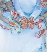  ??  ?? READ MY PALM: The intricate patterns traced on the bride’s hands