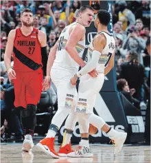  ?? DAVID ZALUBOWSKI THE ASSOCIATED PRESS ?? Nuggets’ Nikola Jokic celebrates a basket with Kitchener’s Jamal Murray, right, against the Portland Trail Blazers on Sunday in Denver.